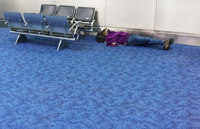 ManSleepsAirportFloor.jpeg