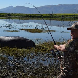 Staging a African fishing story with Sonya holding the fishing pole with her big one story