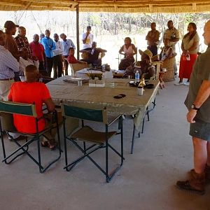 Lon teaches the people of an study-group about hunting