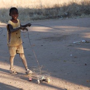 Little boy playing with his car, Namibia