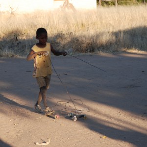 Boy playing with his car Namibia