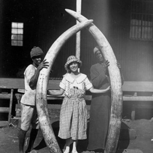 Osa Johnson holding 8 feet Elephant Tusks, circa 1920