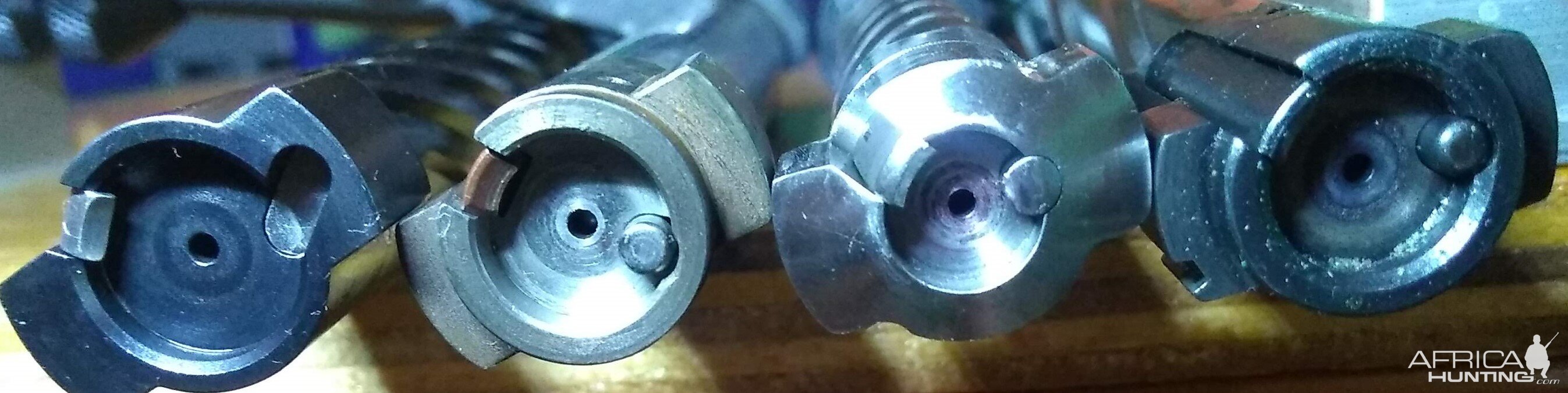 Four bolts out of four different brands of push feed actions