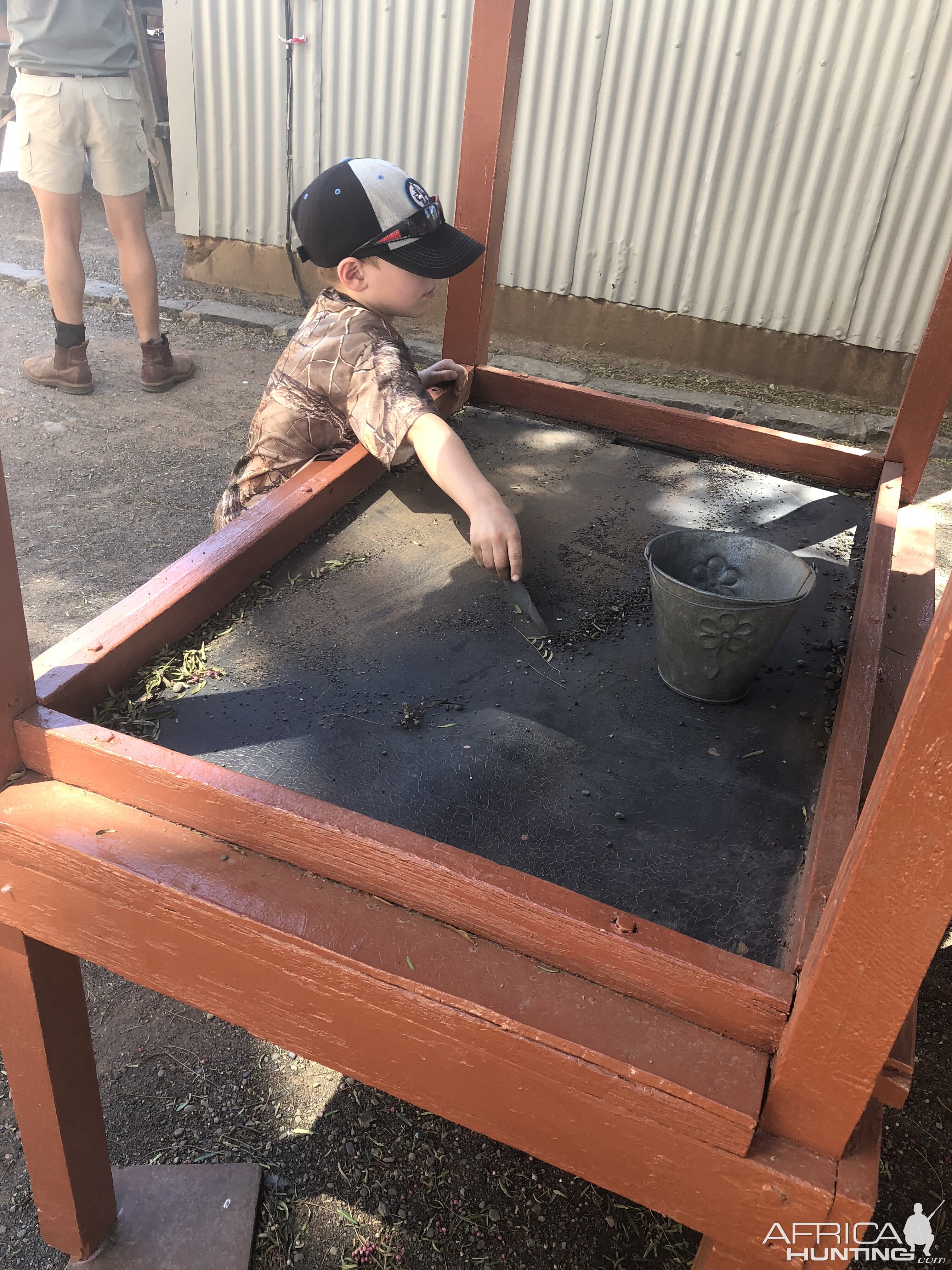 Jeremy busy with bucket of mine tailings