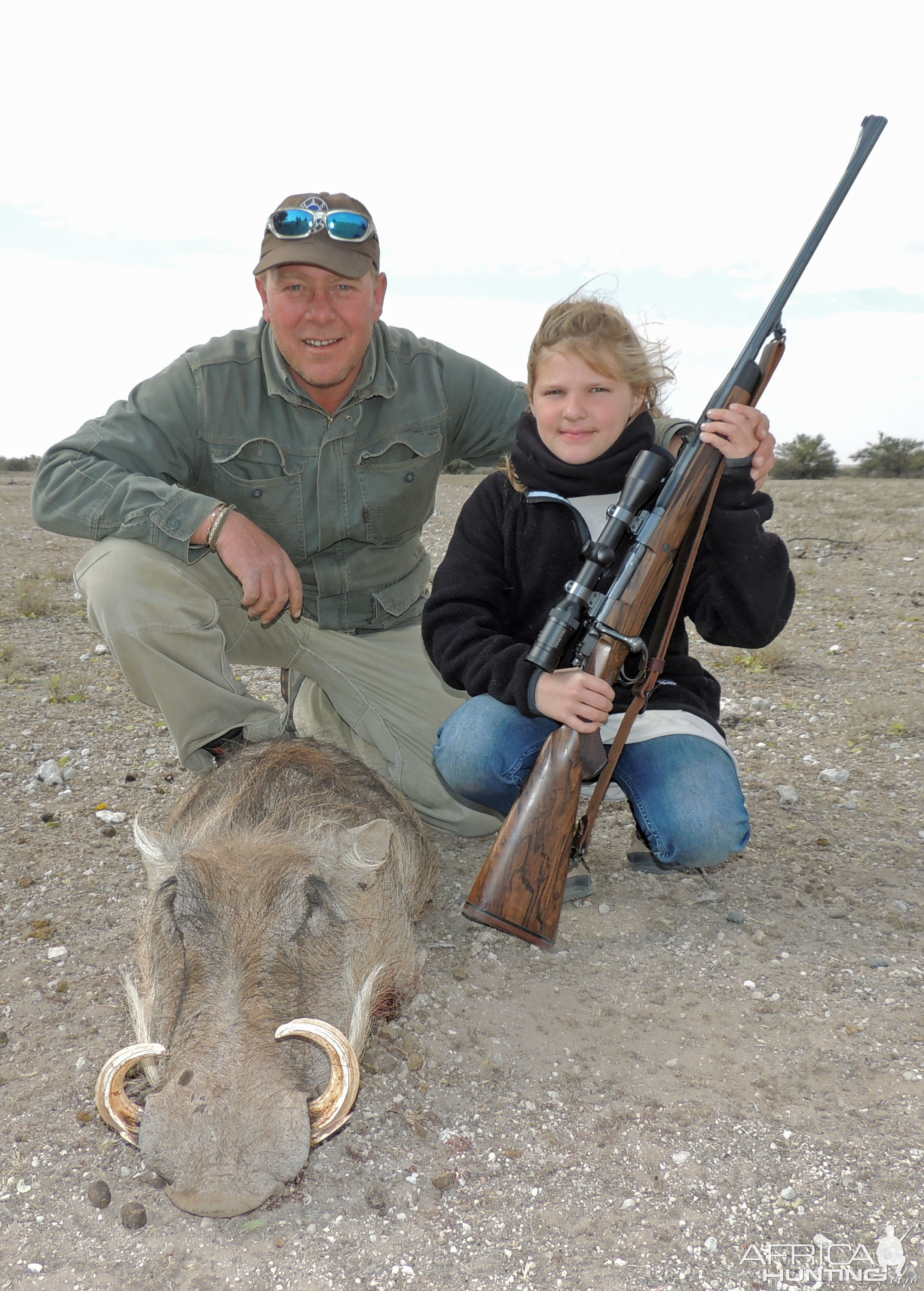 Little girl and first animal in the salt--warthog