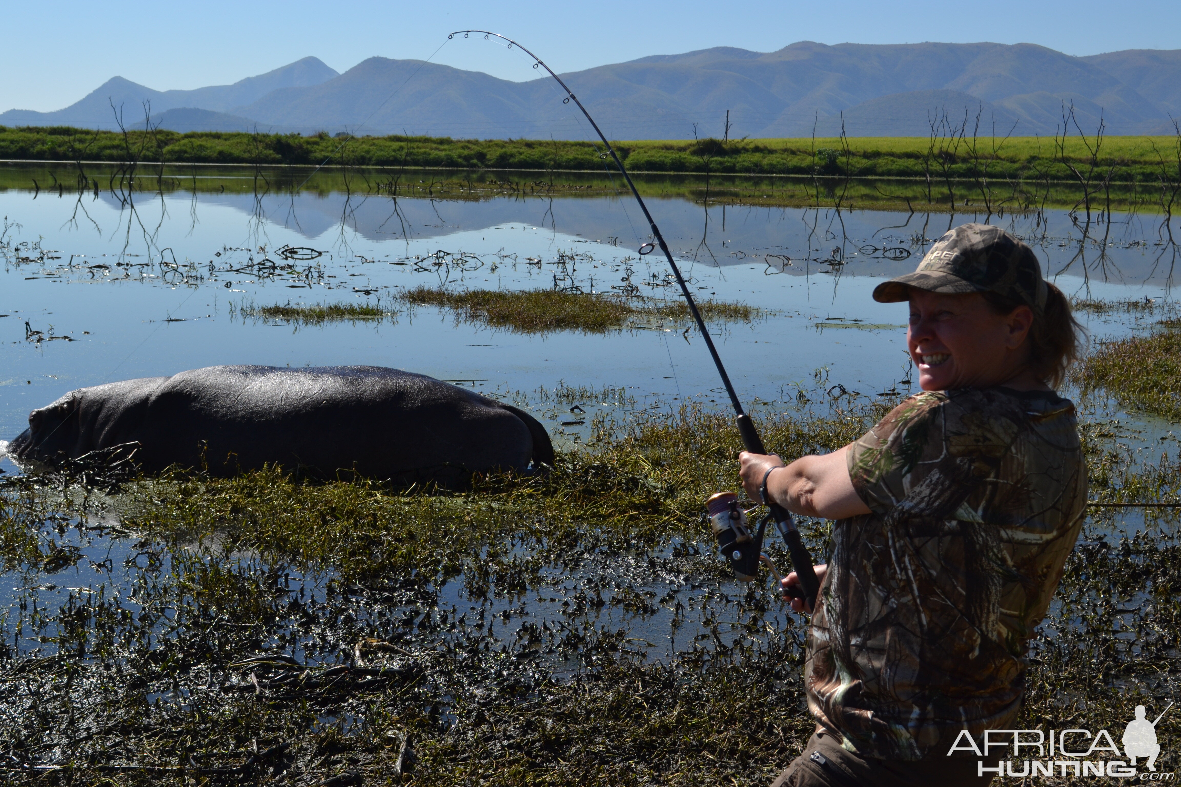 Staging a African fishing story with Sonya holding the fishing pole with her big one story