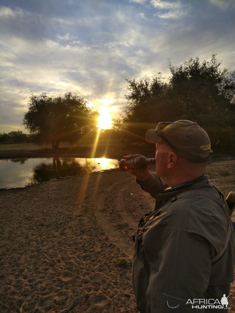 Sundowners at waterhole in South Africa